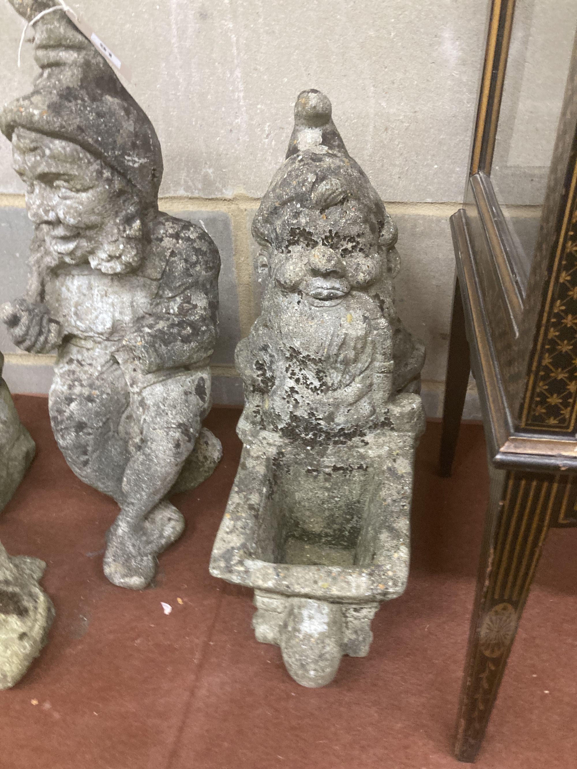 Six reconstituted stone gnome garden ornaments, largest 60cm high